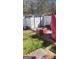 Well-maintained backyard with a shed, brick patio, and green grass at 6880 Mountain Cir, Riverdale, GA 30274
