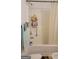 Bathroom featuring a shower-tub combo with shower curtain at 6880 Mountain Cir, Riverdale, GA 30274