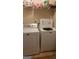 Bright laundry room with a white dryer and washing machine at 6880 Mountain Cir, Riverdale, GA 30274