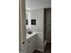 Modern bathroom with white vanity, quartz countertop, art display, and walk-in glass enclosed shower at 175 Forest Lake Dr, Fayetteville, GA 30215