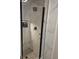 Walk-in glass shower featuring marble tile, black hardware, tiled niche, and rainfall shower head at 175 Forest Lake Dr, Fayetteville, GA 30215