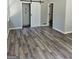 Bedroom featuring wood floors, barn door, closet, and view into ensuite at 175 Forest Lake Dr, Fayetteville, GA 30215