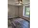 View of a bedroom with hardwood floors, light-gray walls, and a window with a window seat at 175 Forest Lake Dr, Fayetteville, GA 30215