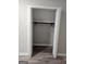 View of a bedroom closet with gray walls, a shelf with a pole for hanging clothes, and bi-fold doors at 175 Forest Lake Dr, Fayetteville, GA 30215