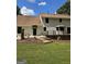 Backyard view of two-story home showcasing a deck, manicured lawn, and inviting outdoor space at 175 Forest Lake Dr, Fayetteville, GA 30215