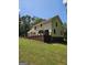 Side of two story home featuring a large wooden deck and manicured lawn at 175 Forest Lake Dr, Fayetteville, GA 30215