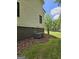 Side view of a home with two AC units surrounded by decorative mulch and grass at 175 Forest Lake Dr, Fayetteville, GA 30215