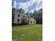 Charming two-story home with front porch, with a well-manicured front yard and lush trees at 175 Forest Lake Dr, Fayetteville, GA 30215