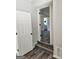 Hallway with wood flooring, white trim, and an open doorway to another room at 175 Forest Lake Dr, Fayetteville, GA 30215