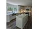 Modern kitchen with white cabinets, stainless steel appliances, an island, and a view of the back yard at 175 Forest Lake Dr, Fayetteville, GA 30215