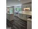 Modern kitchen with white cabinets, stainless steel sink, island, and wood look flooring at 175 Forest Lake Dr, Fayetteville, GA 30215