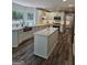 Bright kitchen featuring white cabinets, stainless steel appliances, island, and dark floors at 175 Forest Lake Dr, Fayetteville, GA 30215
