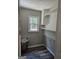 Laundry room with shiplap walls, a window, shelving, and wood look floors at 175 Forest Lake Dr, Fayetteville, GA 30215