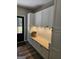 Mudroom with white cabinets, wood countertop, and hooks near a black exterior door at 175 Forest Lake Dr, Fayetteville, GA 30215
