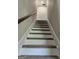 Carpeted stairway features a wooden handrail and leads to the next level of the home at 175 Forest Lake Dr, Fayetteville, GA 30215