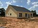 New construction displaying the rear exterior of this light yellow home and dark roof at 1926 King Mill Rd, Mcdonough, GA 30252