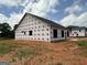 The exterior of the house shows the dark roof and window openings at 1926 King Mill Rd, Mcdonough, GA 30252