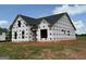 Image shows the side of a new home under construction, featuring a dark roof at 1926 King Mill Rd, Mcdonough, GA 30252
