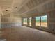 Bright, unfinished living space featuring a vaulted ceiling and large windows at 1926 King Mill Rd, Mcdonough, GA 30252