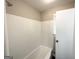 The bathroom features a tub with shower, white tiling, and a bright interior at 2651 Lois Se Ln, Atlanta, GA 30315