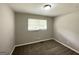 Cozy bedroom with plush carpeting and a window allowing natural light at 2651 Lois Se Ln, Atlanta, GA 30315
