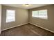 Neutral bedroom featuring plush carpet, natural light, and two windows at 2651 Lois Se Ln, Atlanta, GA 30315