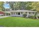 Charming home boasts a well-manicured lawn and inviting curb appeal with a side carport at 2651 Lois Se Ln, Atlanta, GA 30315