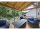 Covered back porch with wood ceiling, outdoor seating and view of the back yard at 1016 Buckeye Ln, Villa Rica, GA 30180