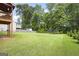 Well-manicured backyard with lush green lawn and mature trees at 1016 Buckeye Ln, Villa Rica, GA 30180