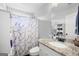 Bathroom featuring a granite-topped vanity, marble shower curtain, and white fixtures at 1016 Buckeye Ln, Villa Rica, GA 30180