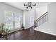 Grand foyer with a staircase, large window, and dark hardwood flooring throughout the entry at 1016 Buckeye Ln, Villa Rica, GA 30180