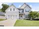 Charming two-story home featuring light gray siding, a well-manicured lawn, and a two-car garage at 1016 Buckeye Ln, Villa Rica, GA 30180