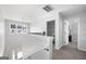 Second floor hallway featuring natural light, neutral paint, and updated railing and trim at 1016 Buckeye Ln, Villa Rica, GA 30180