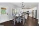 Bright kitchen and dining area with white cabinets, stainless steel appliances, and a stylish chandelier at 1016 Buckeye Ln, Villa Rica, GA 30180