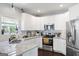 Bright kitchen features granite counters, stainless steel appliances, and ample white cabinetry at 1016 Buckeye Ln, Villa Rica, GA 30180