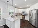 Modern kitchen featuring white cabinets, granite countertops, stainless steel appliances, and a kitchen island at 1016 Buckeye Ln, Villa Rica, GA 30180