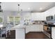 Sunlit kitchen with stainless steel appliances, granite countertops, and an adjacent breakfast area at 1016 Buckeye Ln, Villa Rica, GA 30180