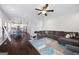 Open-concept living area with hardwood floors, a gray sectional sofa, and a view of the kitchen at 1016 Buckeye Ln, Villa Rica, GA 30180