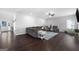 Spacious living room with hardwood floors, a gray sectional sofa, and a comfortable recliner at 1016 Buckeye Ln, Villa Rica, GA 30180