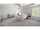 Spacious main bedroom with tray ceiling, carpet, ceiling fan and natural light at 1016 Buckeye Ln, Villa Rica, GA 30180