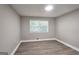 Bright bedroom with hardwood floors, recessed lighting, and natural light from the window at 1939 Sandringham Sw Dr, Atlanta, GA 30311