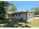 Exterior of the home showcasing a freshly painted exterior with mature trees at 1939 Sandringham Sw Dr, Atlanta, GA 30311