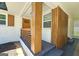 Stylish front porch with modern wood accents, a vibrant door, and tasteful landscaping for an inviting entrance at 1939 Sandringham Sw Dr, Atlanta, GA 30311