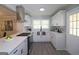 Modern kitchen featuring stainless steel appliances, white cabinetry, and hardwood floors at 1939 Sandringham Sw Dr, Atlanta, GA 30311