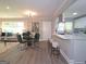 Open-concept living and dining area featuring hardwood floors, lots of natural light, and stylish furniture at 1939 Sandringham Sw Dr, Atlanta, GA 30311