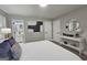 Well-lit main bedroom featuring sleek flooring, modern decor, and an ensuite bathroom at 1939 Sandringham Sw Dr, Atlanta, GA 30311