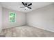 Bright bedroom with a ceiling fan and view of foliage from the window at 89 Prospect Path, Hiram, GA 30141