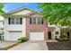 Charming townhome with a brick facade, attached garages, and well-maintained landscaping at 89 Prospect Path, Hiram, GA 30141