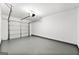 Clean, empty garage featuring a white door and gray painted floors at 89 Prospect Path, Hiram, GA 30141