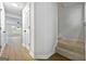 Hallway featuring vinyl floors, stairs, and an open living space with natural light at 89 Prospect Path, Hiram, GA 30141